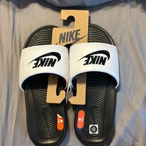 White and black Nike slides